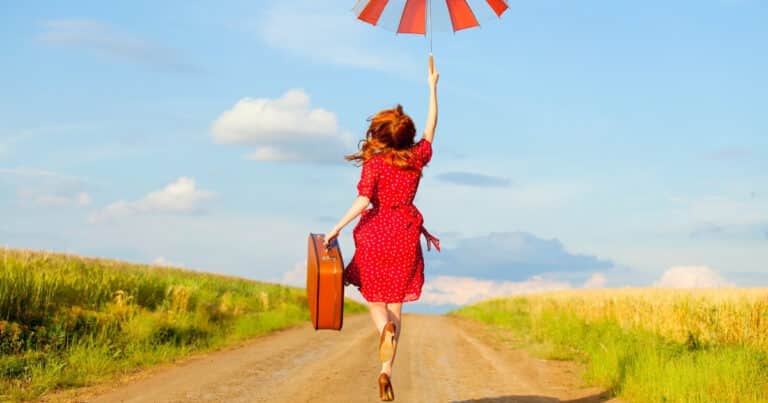 Woman with umbrella jumps for joy | Scared to travel alone