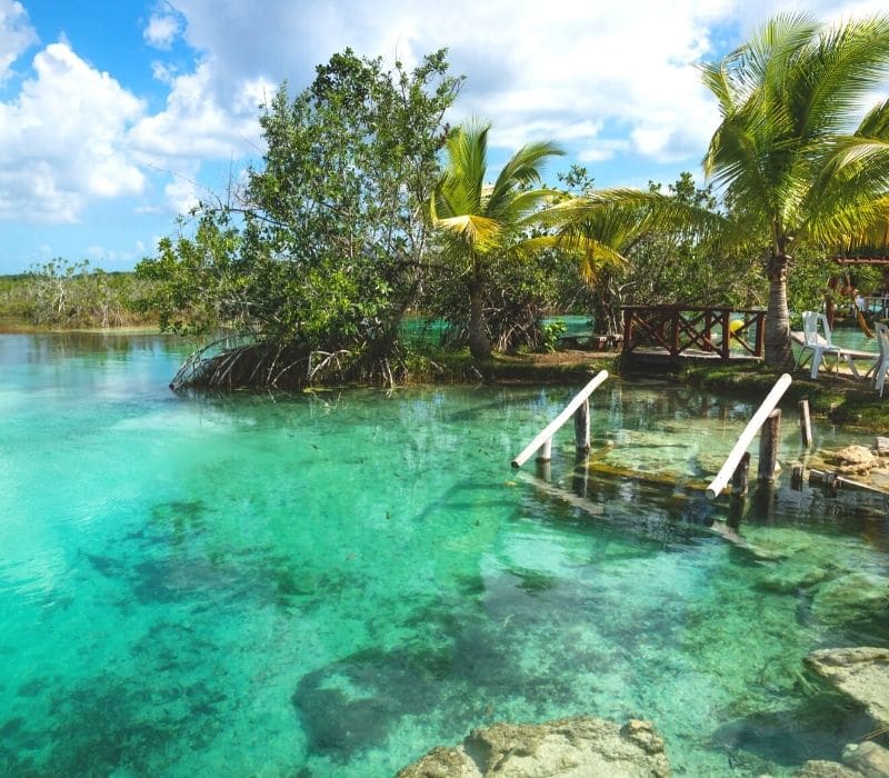 staircase going into the blue water at Los Rapidos in bacalar lagoon mexico