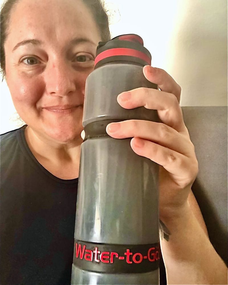woman with grey reusable water bottle by Water-To-Go