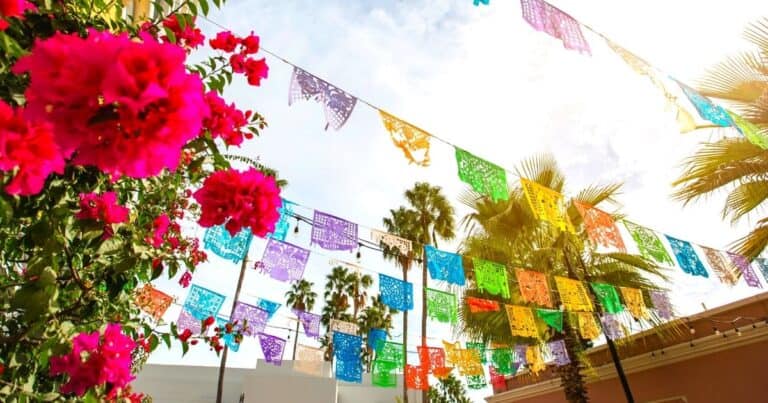 colorful paper flags and pink flowers in one of the Safest Cities in Mexico