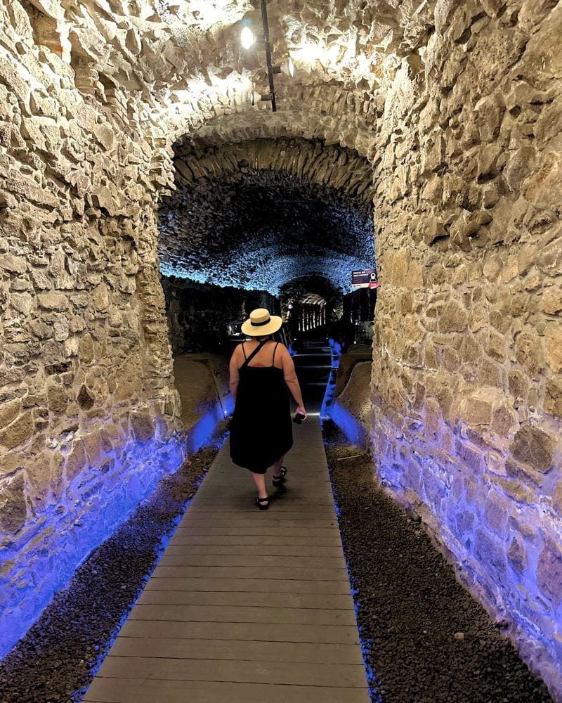 woman walking through the puebla tunnels located under puebla city, mexico