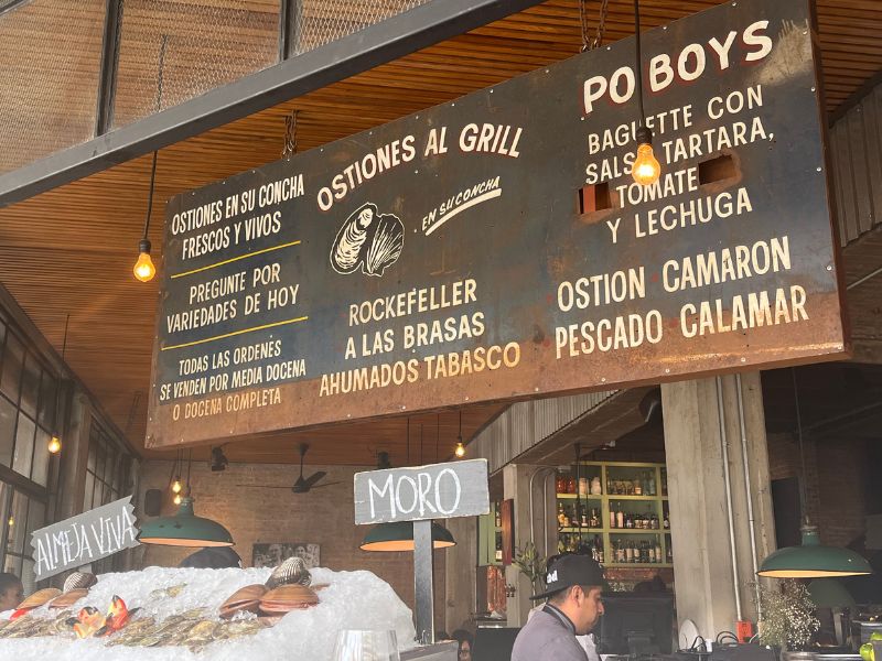Oyster bar and hand-painted menu boards at La Docena in Mexico City