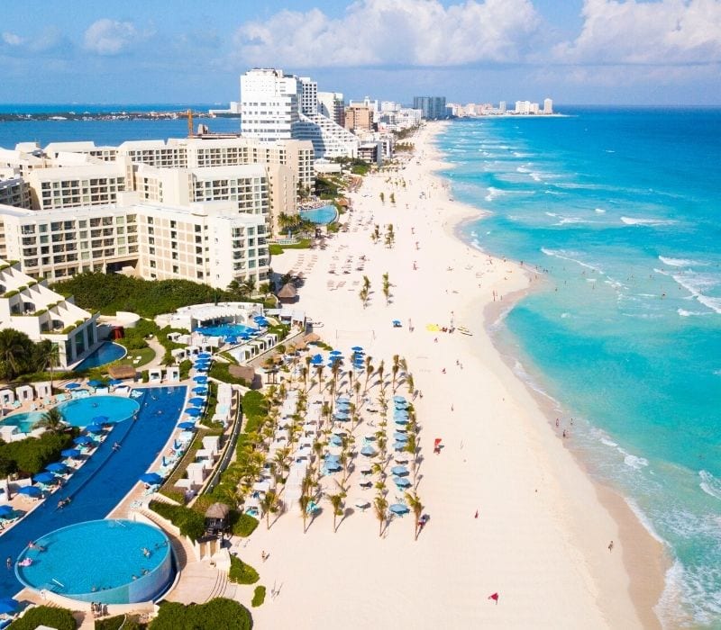 cancun beach - with white sand, blue water and hotels along the sand