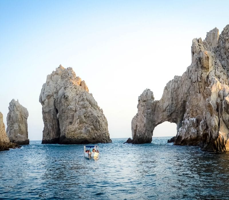 boat near the granite formation in the ocean called The Arch - Cabo San Lucas private boat tours
