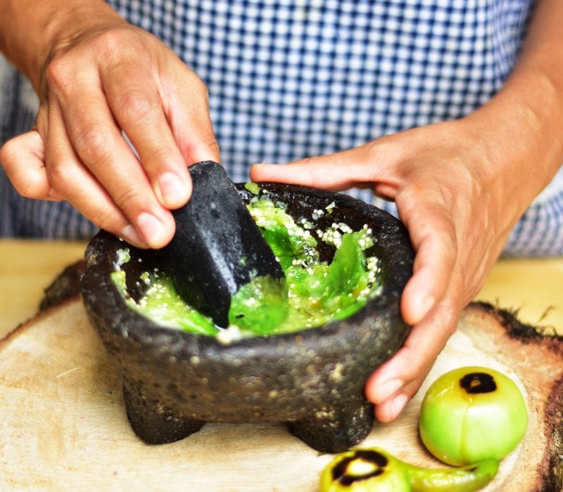 woman making green chili sauce