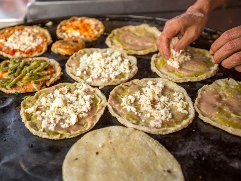 person making mexican sopes