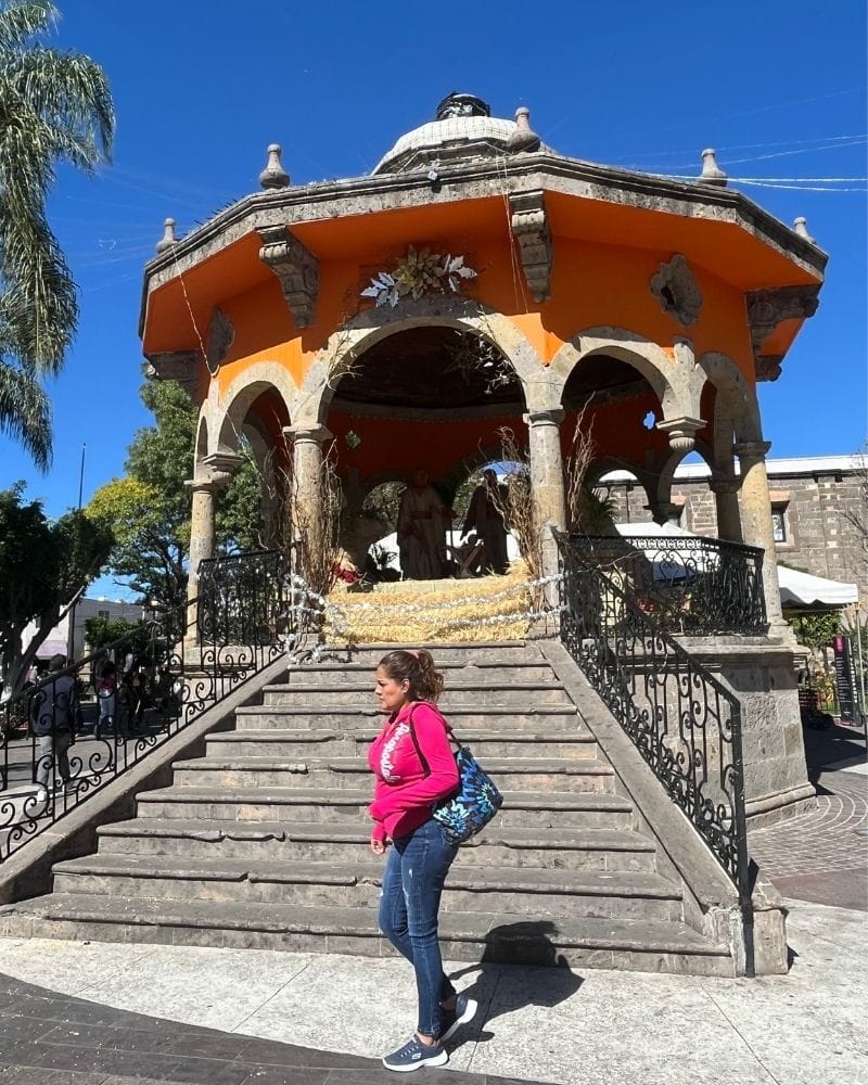 woman walking in front of Quiosco de Hidalgo gazebo in Tlaquepaque