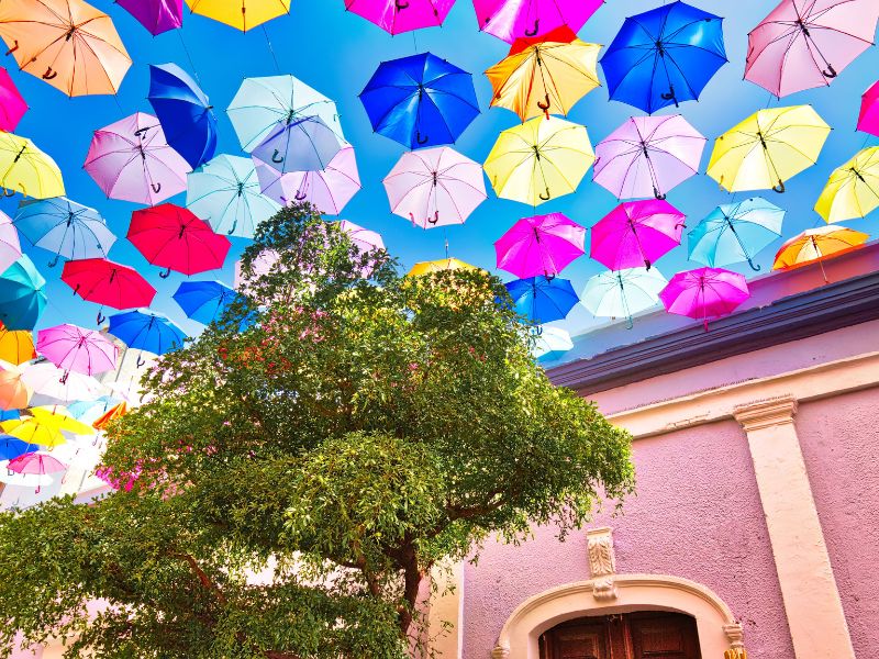 colorful umbrellas hanging over a street in Tlaquepaque Jalisco Mexico