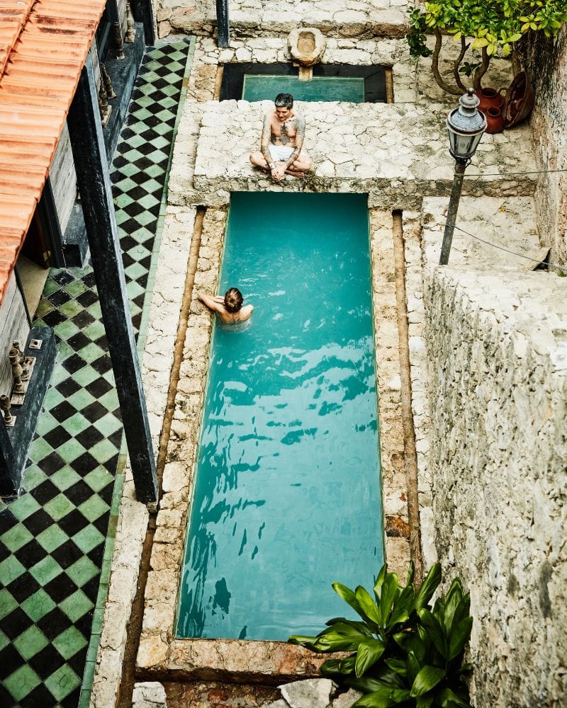 couple at the pool of Coqui Coqui Casa de los Santos hotel in Izamal