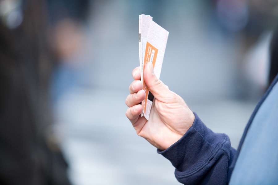 woman holding tickets
