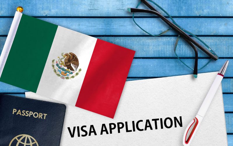passport with visa application papers and flag of mexico