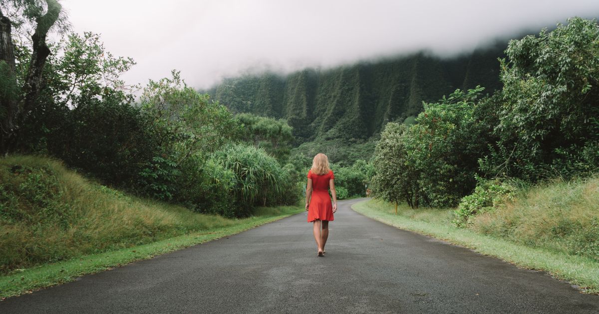 woman in red in the middle of the road