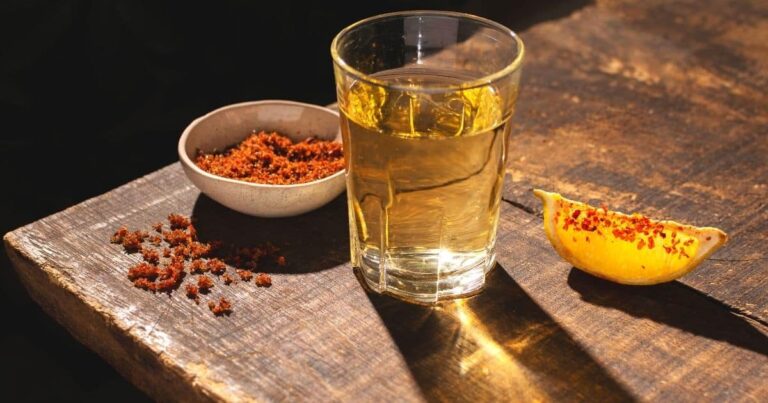 cup of mezcal, and orange wedges | best mezcal from oaxaca