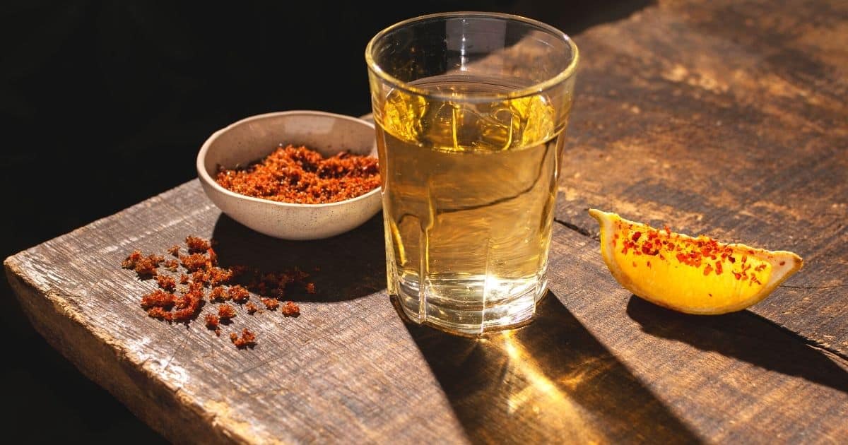cup of mezcal, and orange wedges | best mezcal from oaxaca