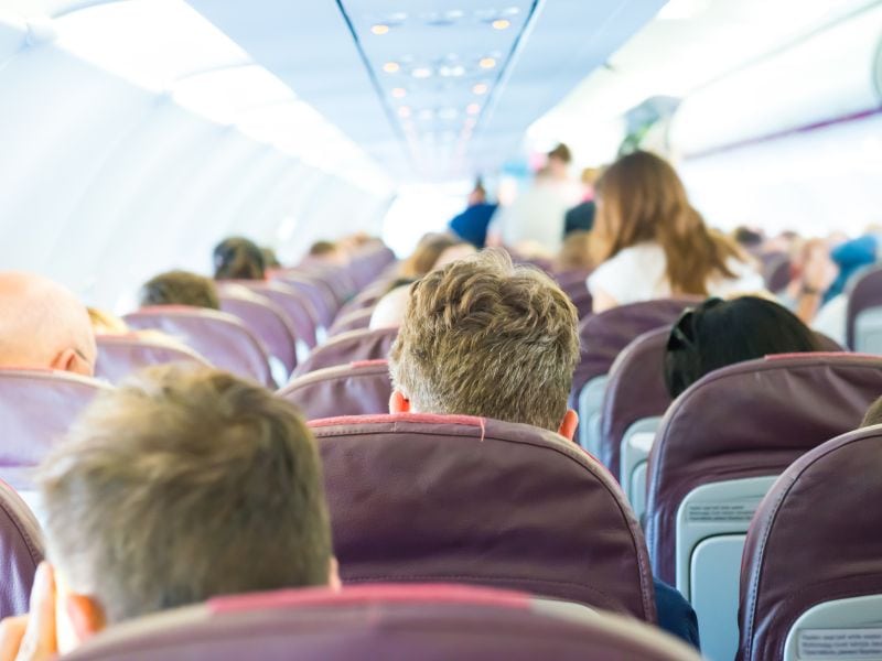 back of people's heads on a full flight