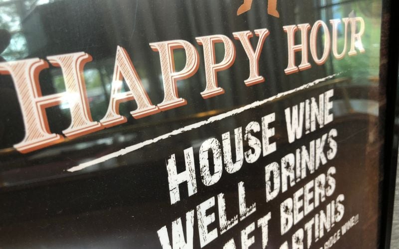 happy hour signage on a restaurant