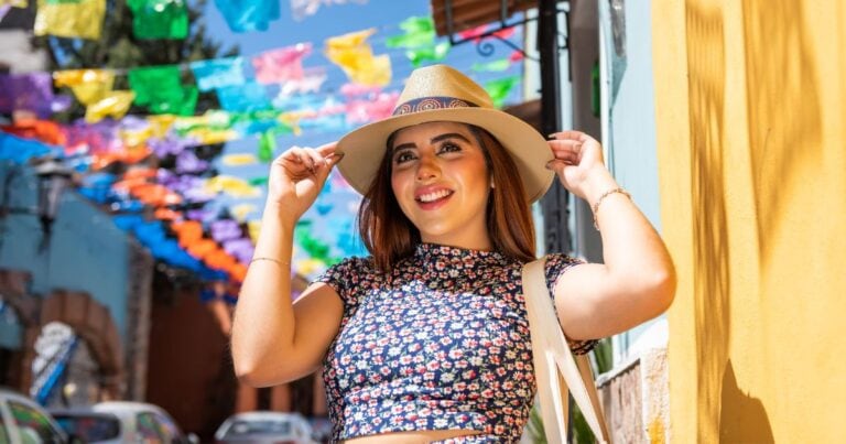 woman on a colorful street in her favorite oaxaca outfits