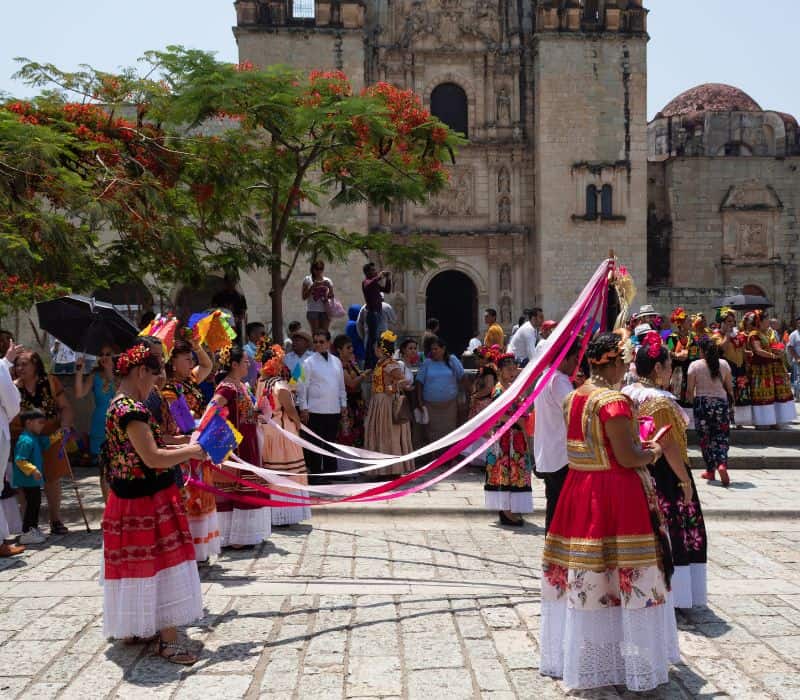 locals wearing traditional dresses during oaxaca festival