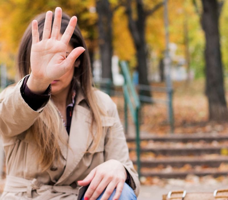 woman holding out her hand saying no