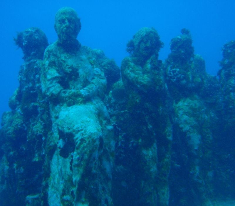 sculpture of different person images underwater museum