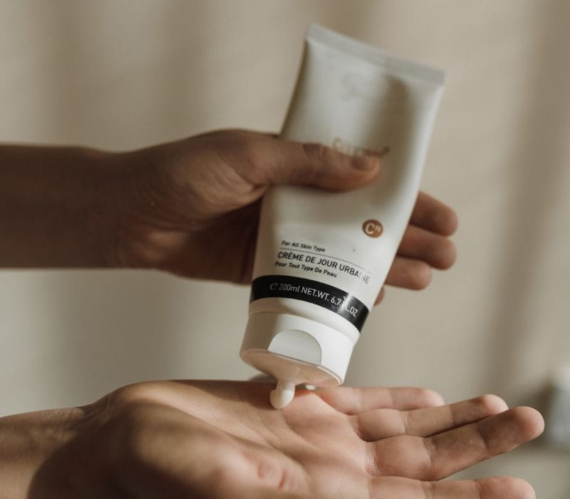 squeezing moisturizer to hands | long flight preparation