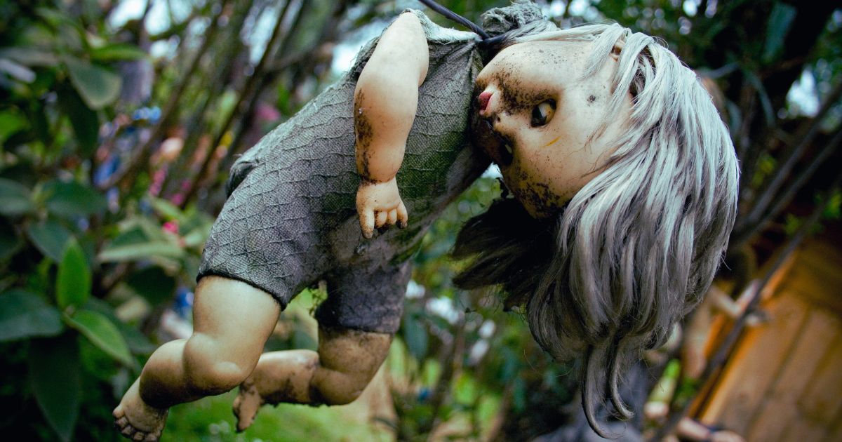 creepy doll hanging from a tree at the Island of the Dolls Mexico City