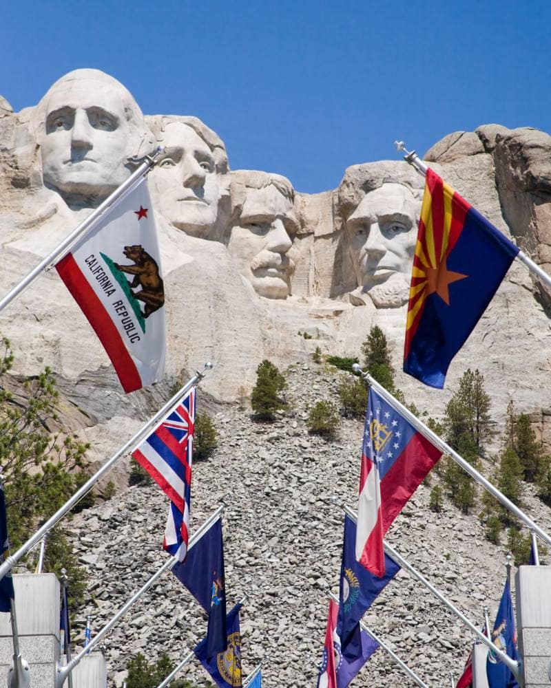 flags surrounding mount rushmore