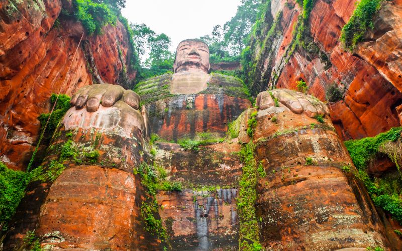 Leshan Giant Buddha mountain carving surrounded by greenery