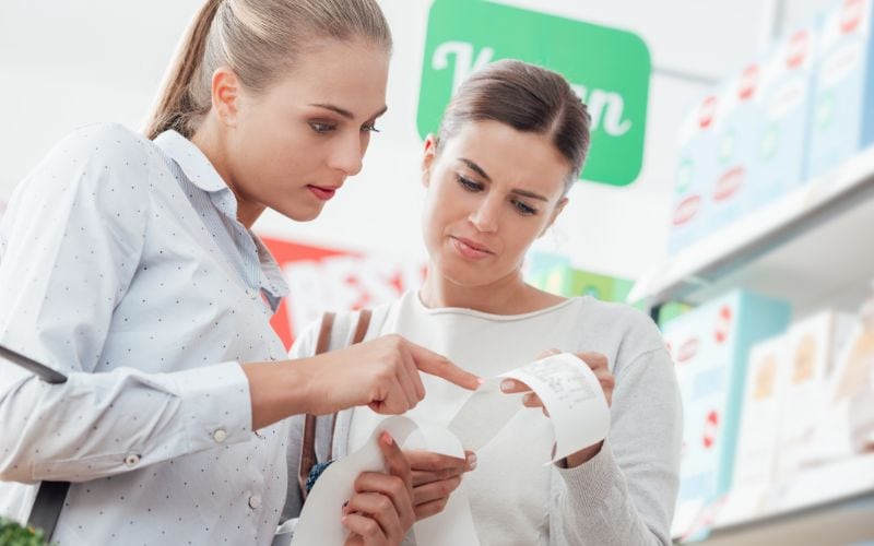 two women checking their grocery bill
