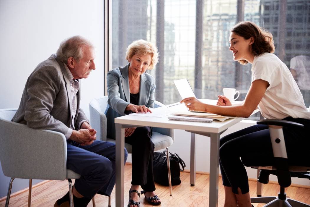 Senior Couple Meeting with Female Financial Advisor in Office
