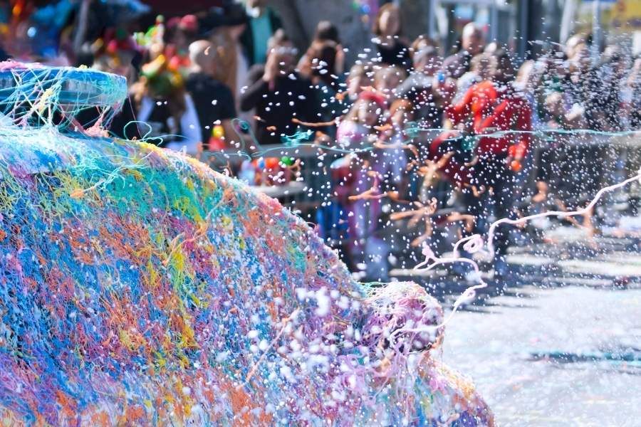Street carnival with silly strings and artificial snow