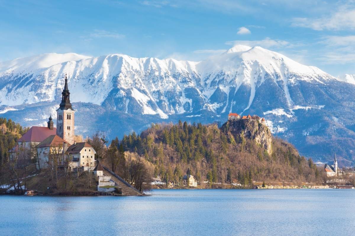 Panoramic view of Julian Alps, Lake Bled with St. Mary's Church on Assumption on a small island