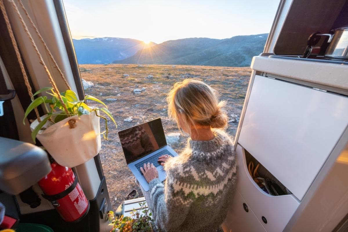 Woman working remotely, van life concept, hush trip