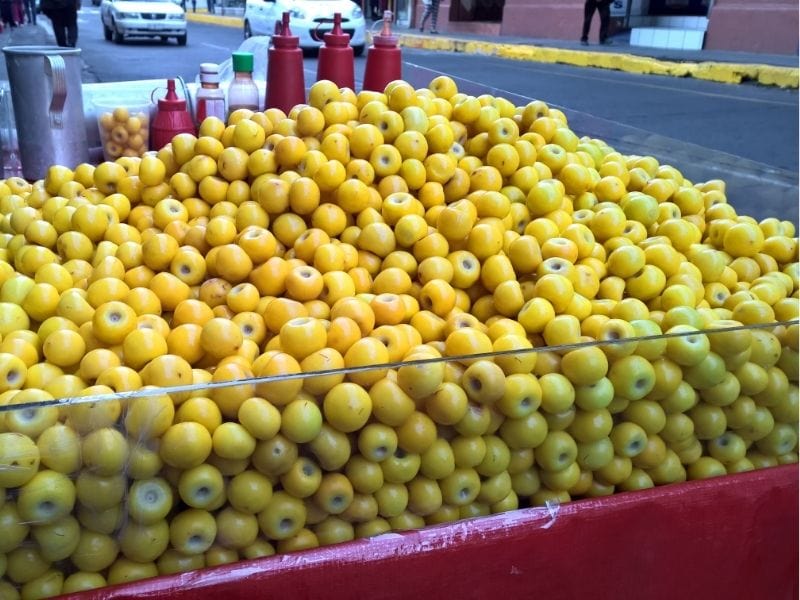 vendor selling Nanche fruit (Yellow Mombin)