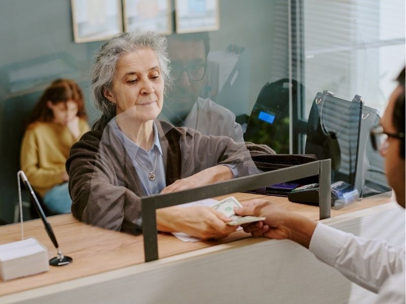 older woman at a bank teller window
