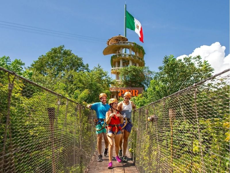 people on the suspension bridge at Xplor park Xcaret Mexico
