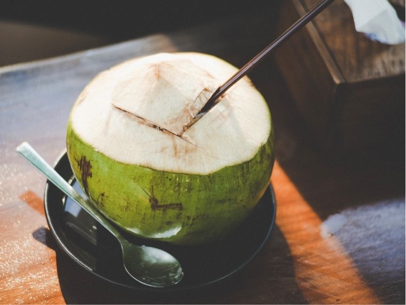 coconut with straw in it