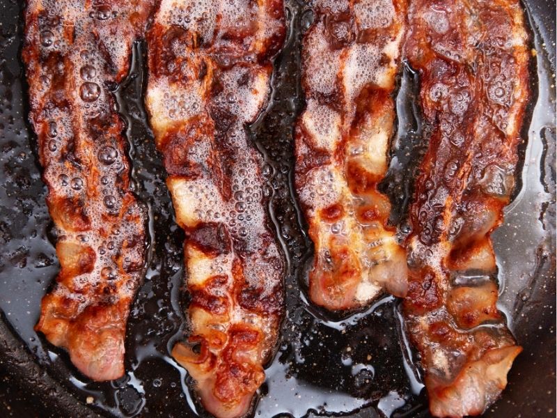 bacon frying in a pan