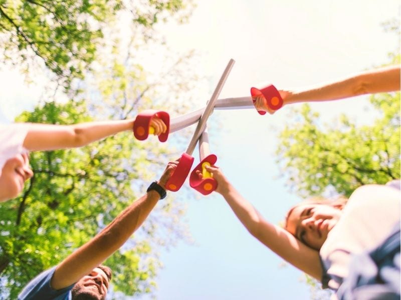 4 kids playing with toy swords