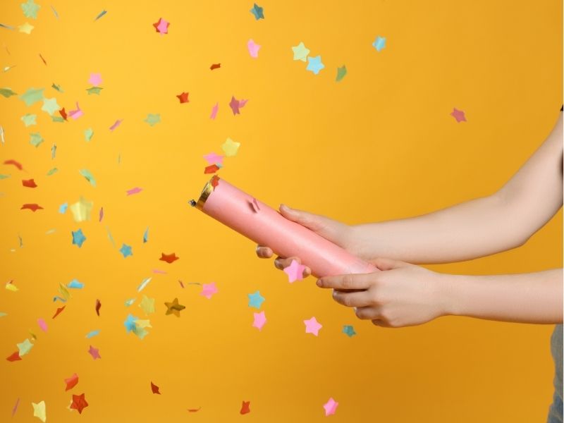 party popper spraying confetti