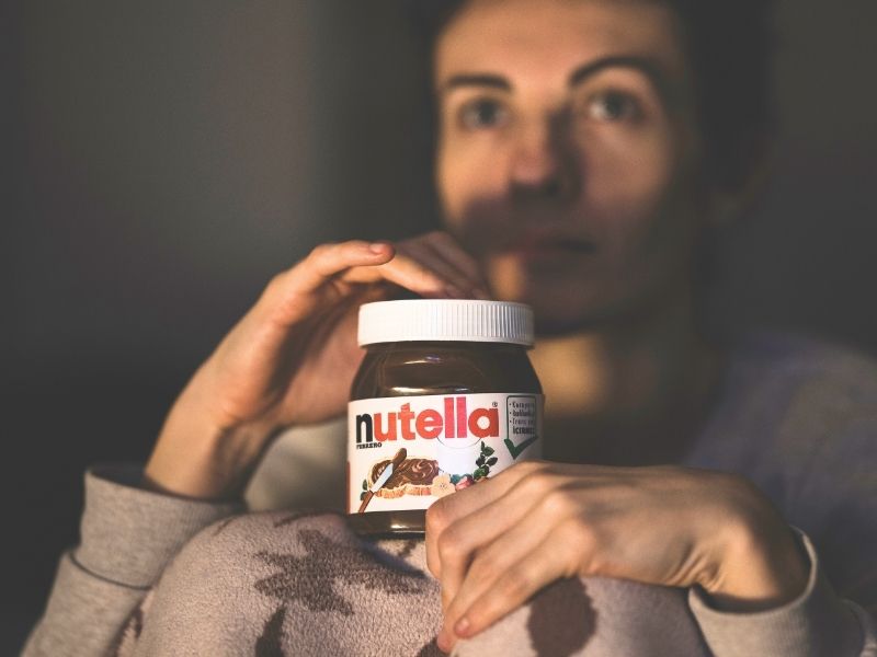 woman holding jar of Nutella