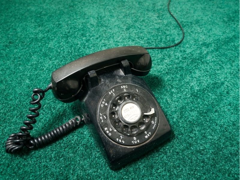 rotary phone on green shag carpet