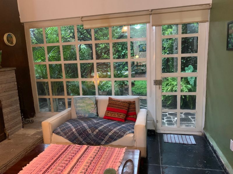 Sitting room with a window onto the garden at the 2-Bedroom Garden Home in Coyoacán, Mexico City