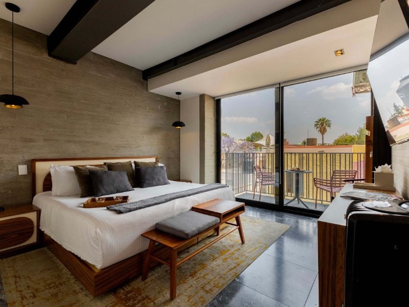 Bedroom with a king bed and balcony doors at the 3-Bedroom Polanco Apartment by Masaryk, Mexico City