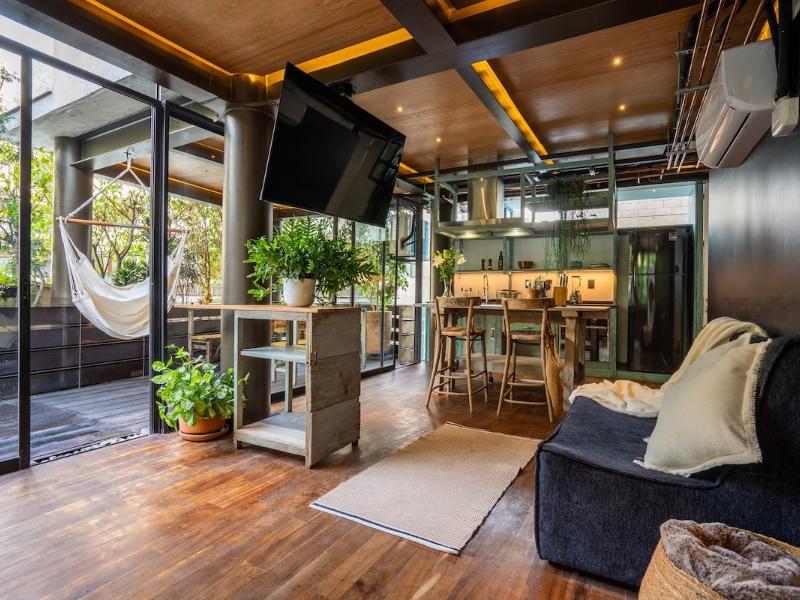 Living area with a hammock and leafy views at the vintage loft Airbnb in Condesa, Mexico City