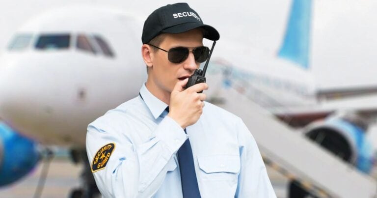airport security officer on a walkie-talkie at the Cabo airport, checking the cabo tourist tax