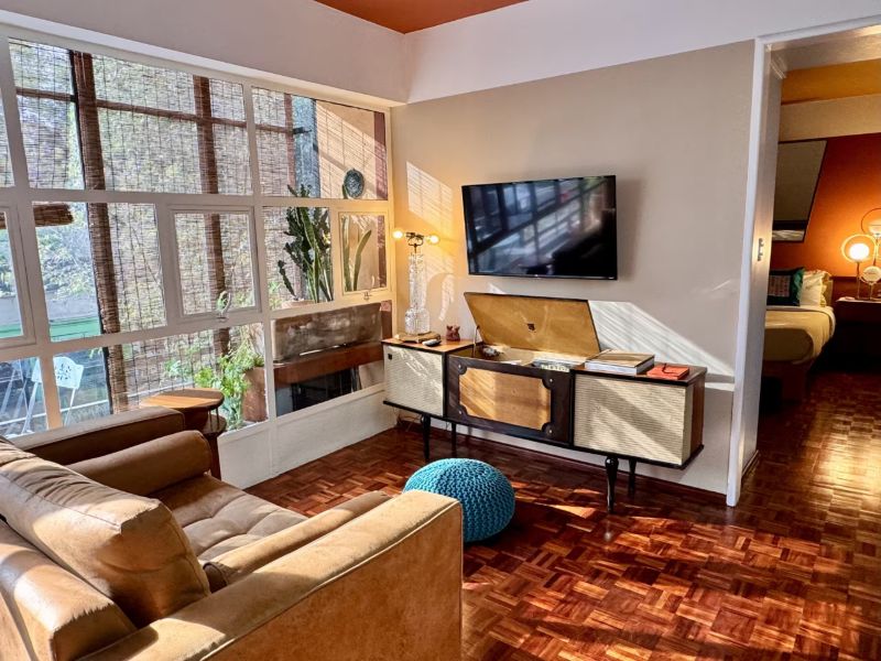 Retro-style living room at Casa Apache Airbnb in Roma Norte, Mexico City