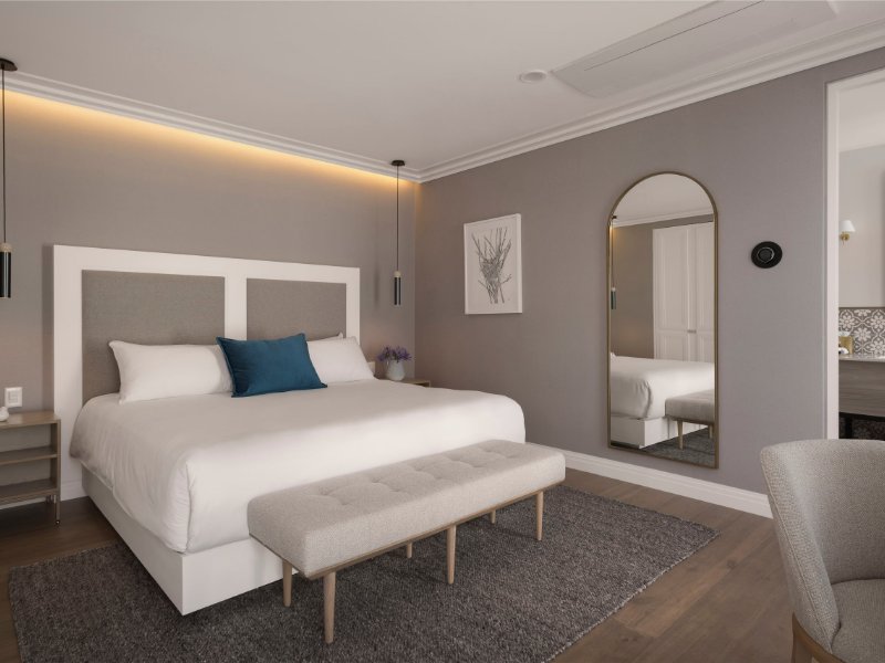 King bed and arched mirror in the suite at Casa Cleo, facing Parque México in Condesa, Mexico City