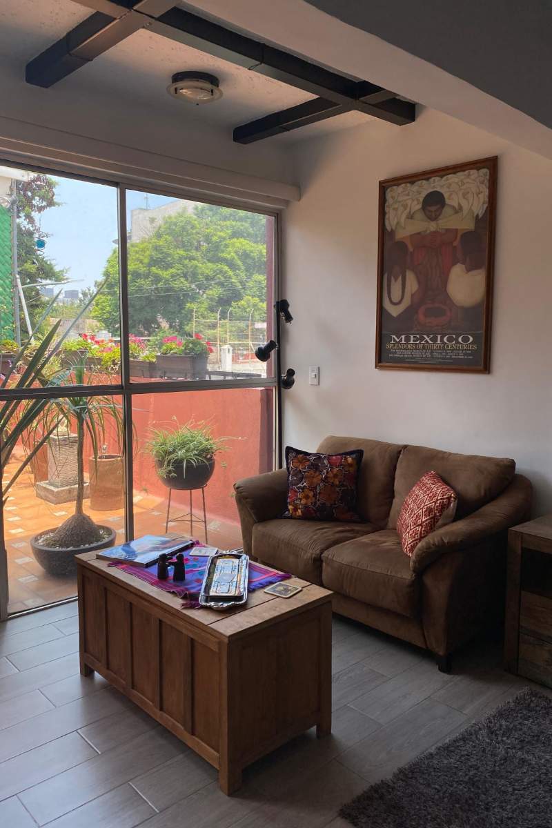 Loft with a big window and Mexican art poster at the Casa de la Sierra Loft in Guadalupe Inn, Mexico City