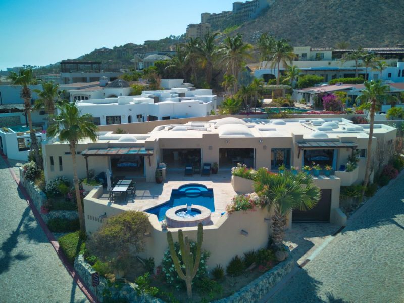 Aerial view of Casa Dorado's pool and hot tub on the Pedregal hillside, a Cabo Airbnb with a chef